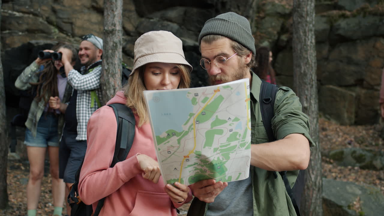 Hikers consulting map in the forest