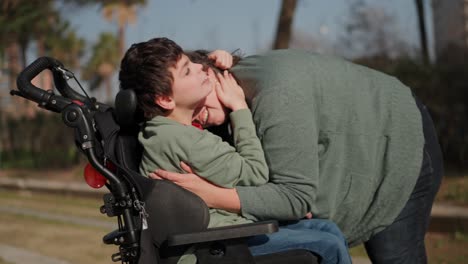 a touching moment between a mother and her child in a wheelchair