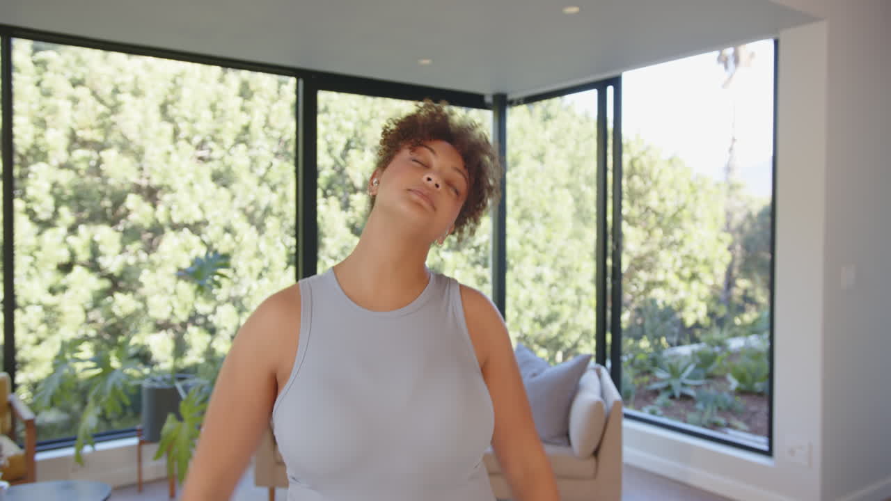 Exercising indoors, plus size woman in workout attire focusing on fitness