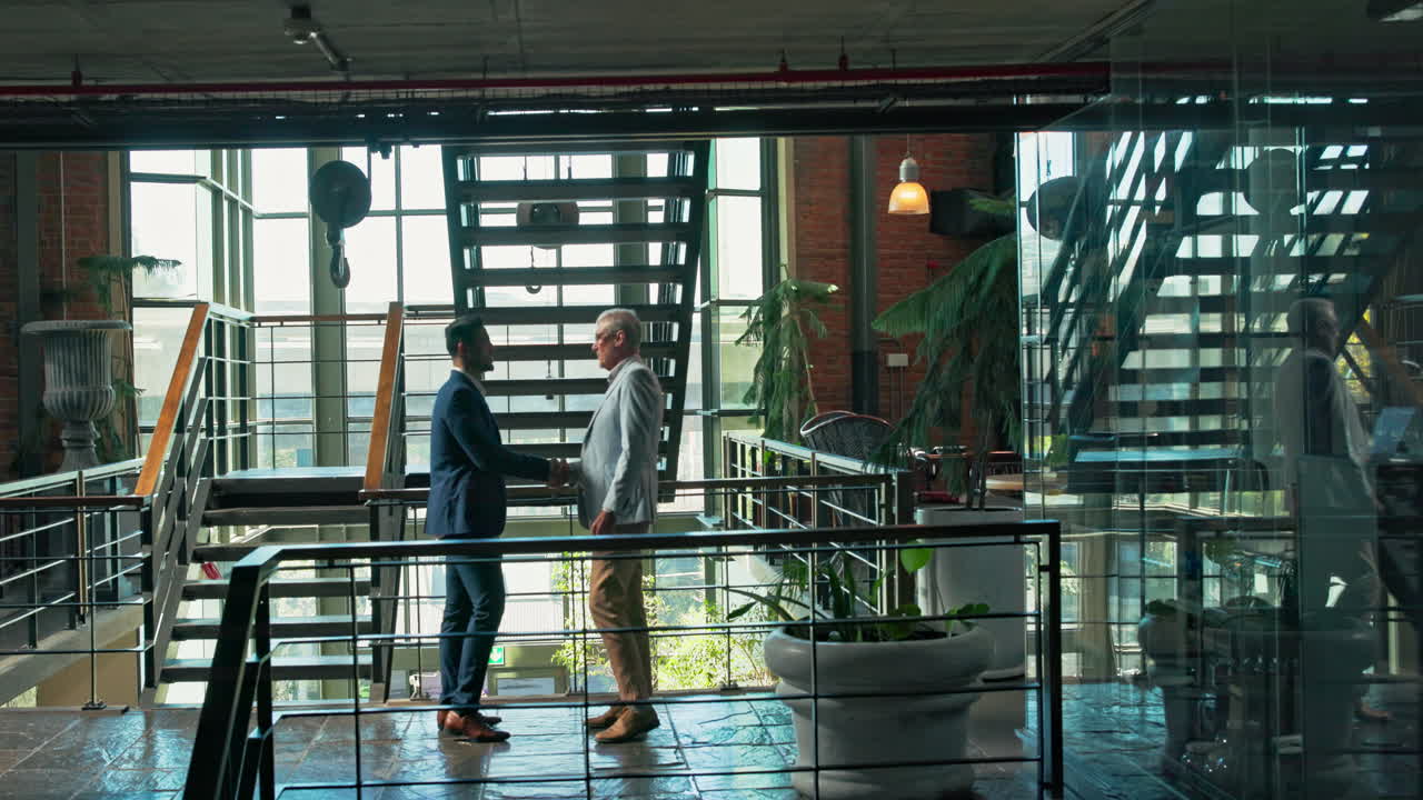 Businessmen shaking hands in modern office