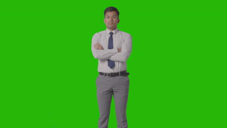 portrait of serious businessman in shirt and tie against green screen looking at camera 1