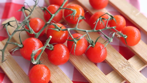 fresh cherry tomatoes on a wooden tray