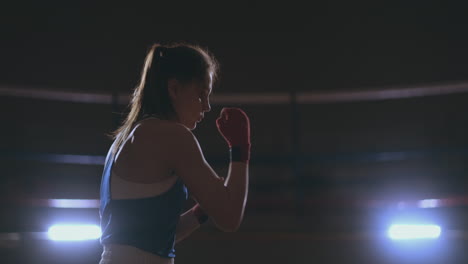 Athletic-woman-doing-fitness-exercises-to-box-and-practice-self-defensive-techniques.-steadicam-shot