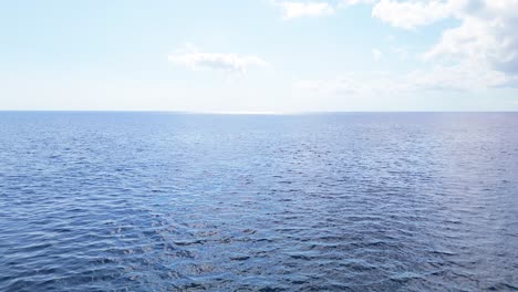 drone descends to ocean water surface with beautiful mesmerizing tropical blue ripples