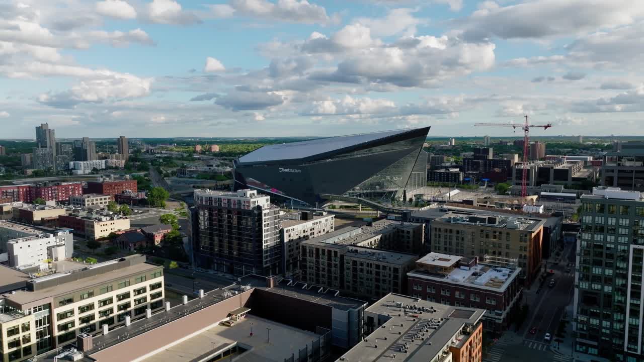 slow push in aerial drone shot of The Viking's US Bank stadium in downtown Minneapolis Minnesota