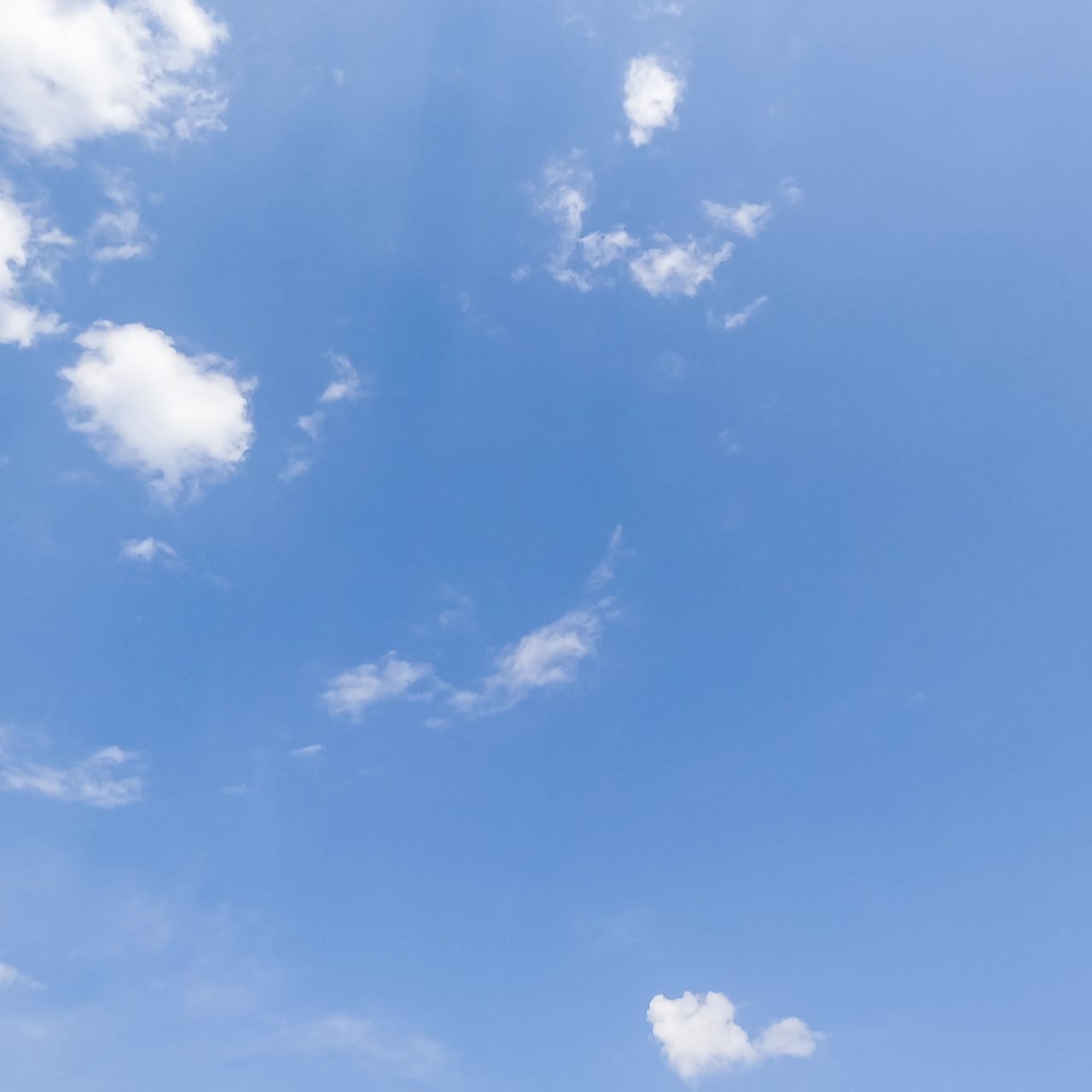 Amazing light cotton clouds fly away and disappearing in the sky. Blue horizon cleaning from clouds timelapse. Low angle view