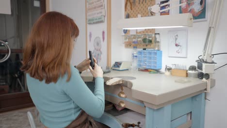 woman working on jewelry in a craft workshop