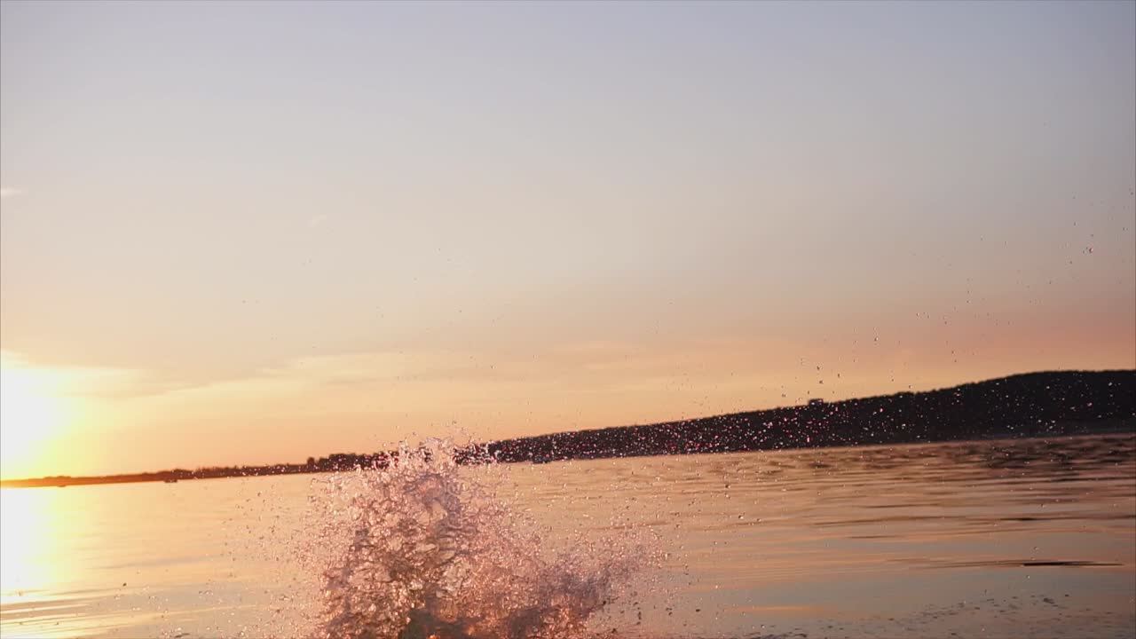 Sunset over the water with boat