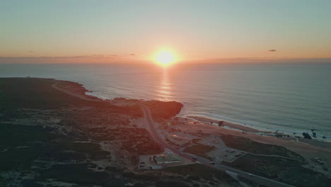 drone view coast sunrise greeting beach with golden light. serene ocean aerial