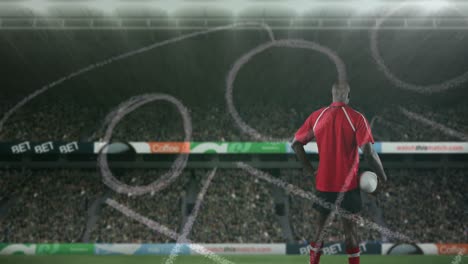 Animation-of-position-plan-over-african-american-man-with-rugby-ball-at-stadium