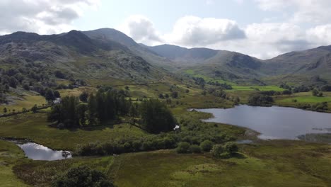 Little-Langdale-tarn-,-sunny-day-Lake-district-UK-Aerial-pan