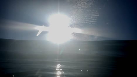 wave cresting and breaking over camera with the sun shining, in southern camera