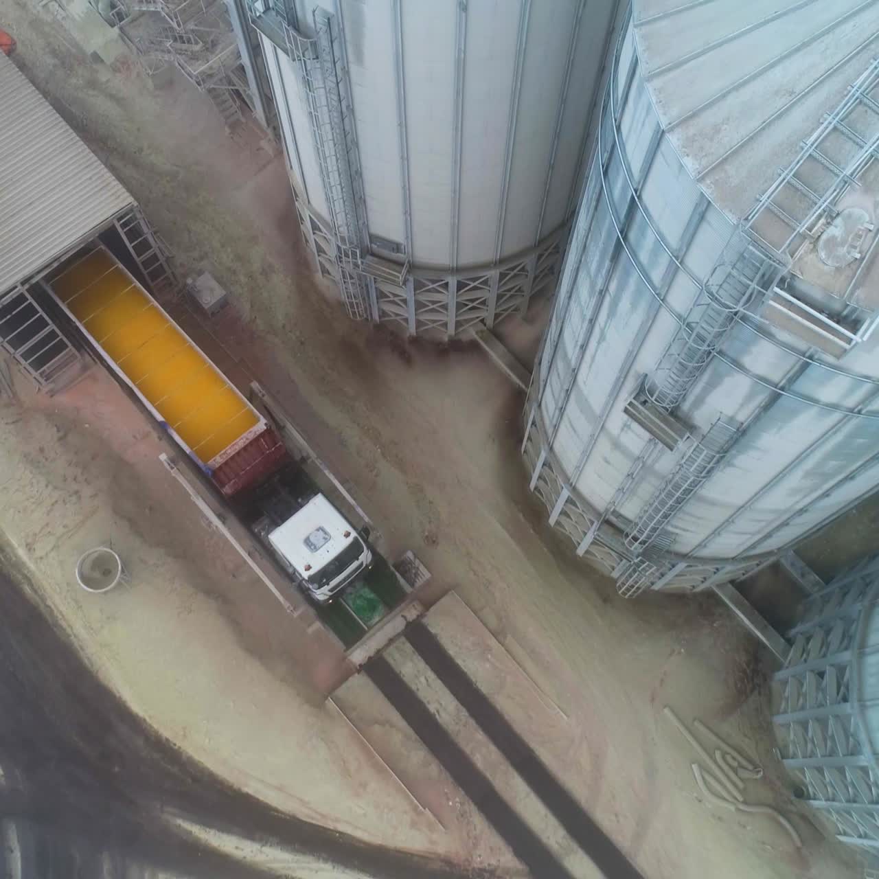 Aerial view of huge metal storage construction. Steel big wheat grain elevator
