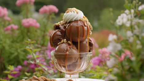 delicious chocolate caramel ice cream sundae in a garden