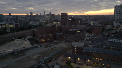 rising establishing drone shot over outskirts of leeds city centre and bridgewater place in low light before sunrise