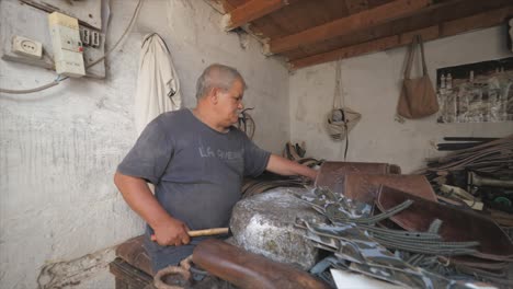 craftsman working with hammer in his workshop and repairing some stuff