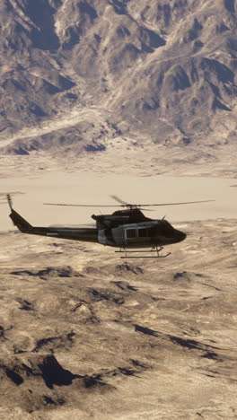 helicopter flying over desert mountains