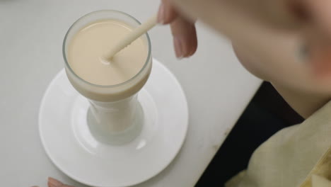 Woman-drinking-horchata-in-cafe