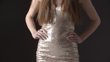 tilt shot of glamorous young woman in sparkly evening dress