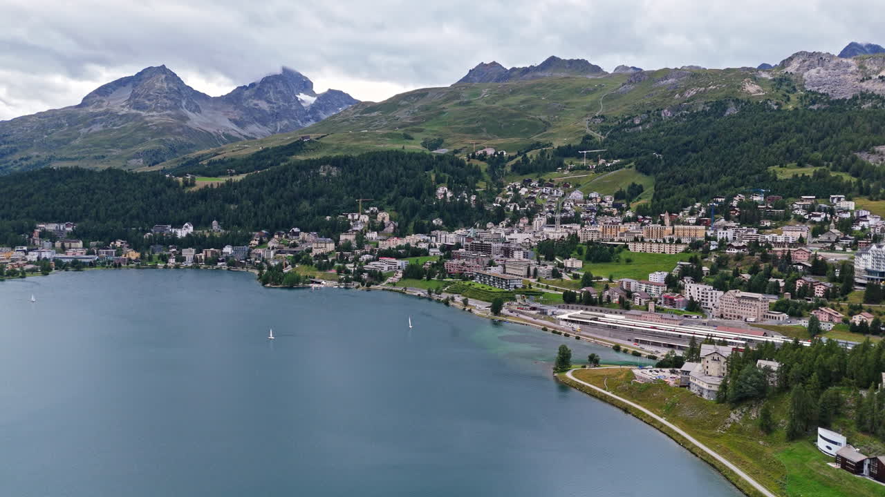 Aerial view of Saint Moritz by a lake with scenic mountain backdrop