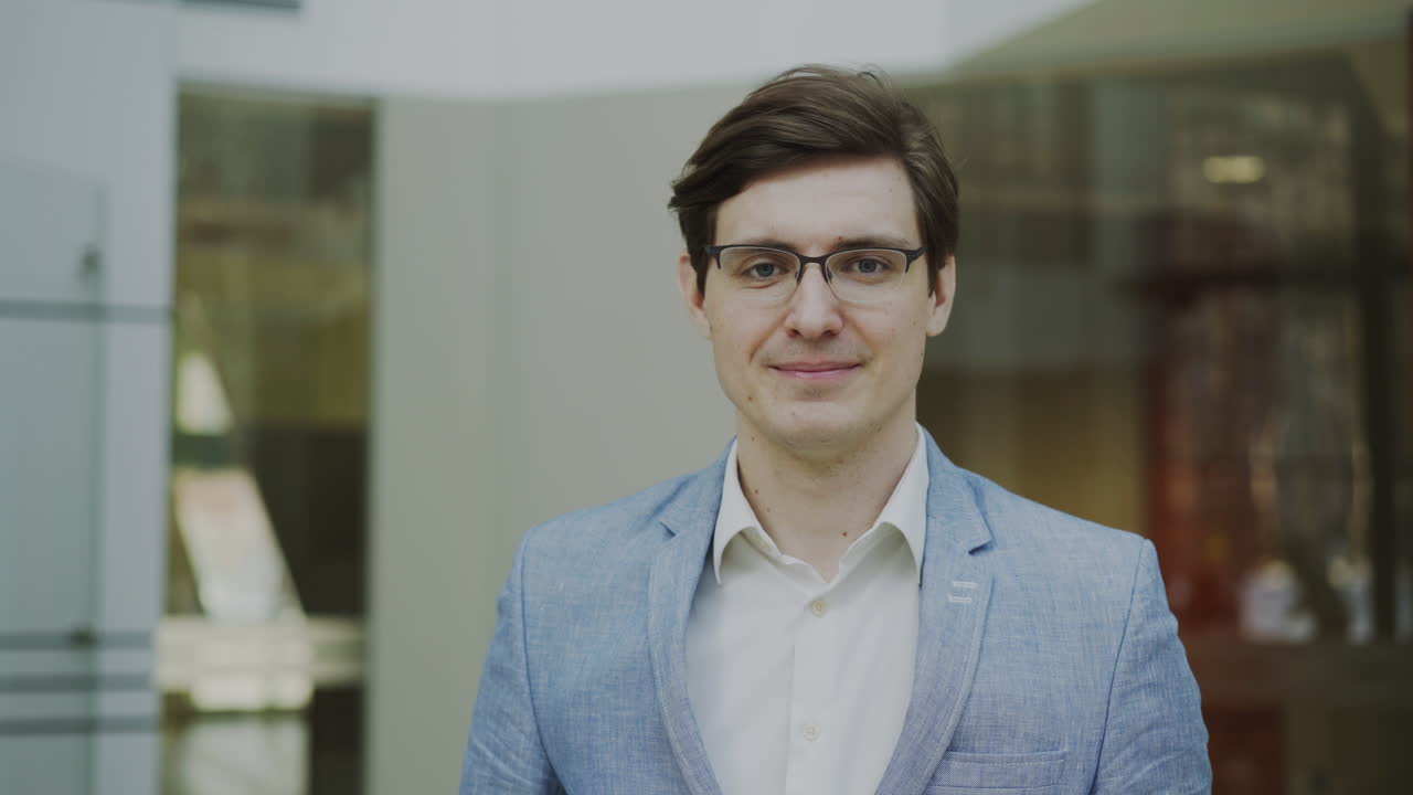 Man in a light blue blazer smiling