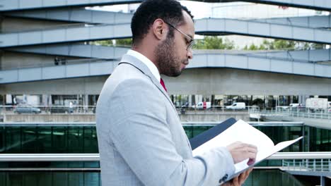 Serious-businessman-walking-with-folder