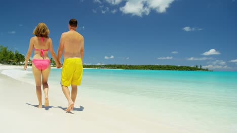 caucasian couple in swimwear on luxury beach vacation