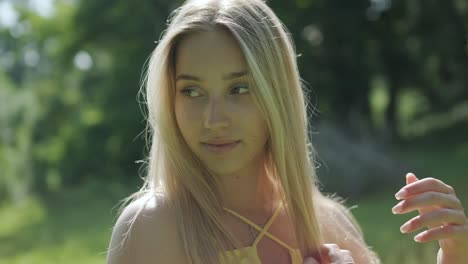 woman in yellow dress dancing gracefully in summer park