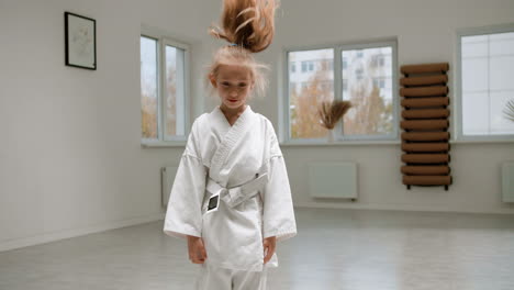 girl in white kimono in martial arts class