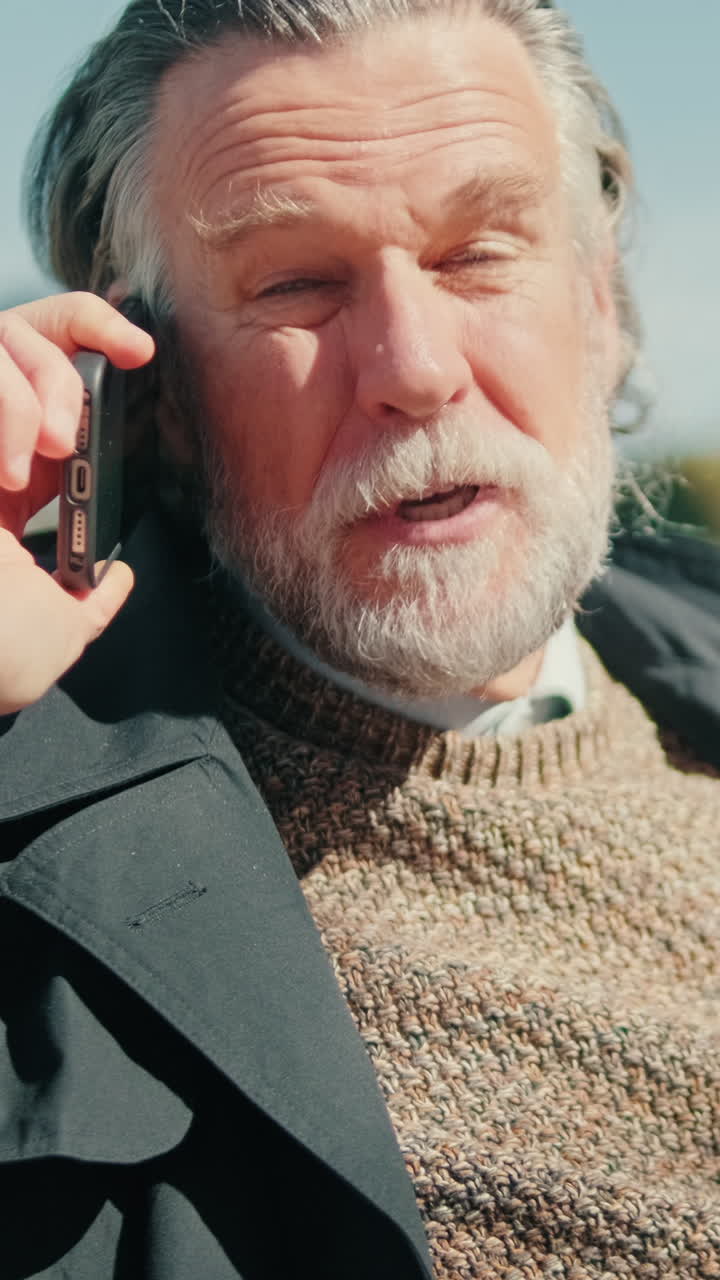 Senior Man Talking on Cell Phone in Park