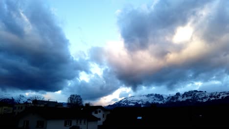 Burst-timelapse-of-heavy-moving-clouds-above-swiss-alps-mountain-with-blue-sky