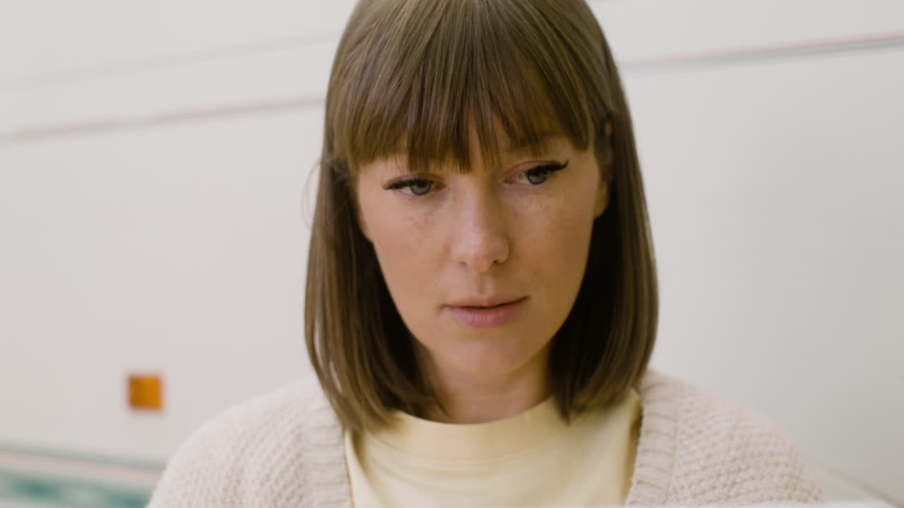 Concentrated woman working on laptop computer outdoors