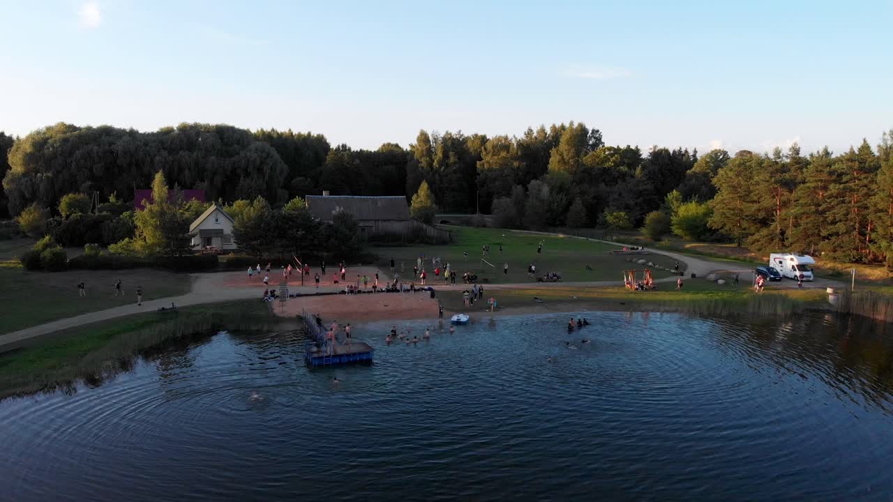 Drone shot of a small lake in rural Lithuania during golden hour