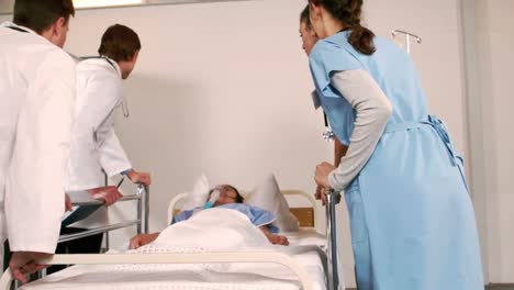 patient receiving oxygen mask from medical team