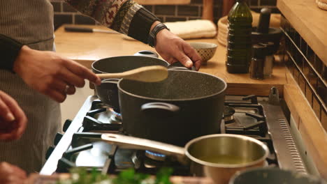 a couple cooking and laughing together in their kitchen