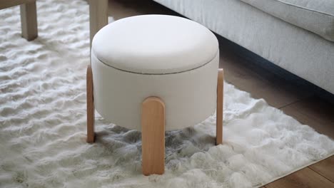 stylish white round ottoman with wooden legs