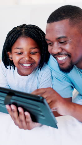 Father,-teaching-and-child-with-tablet-in-bedroom