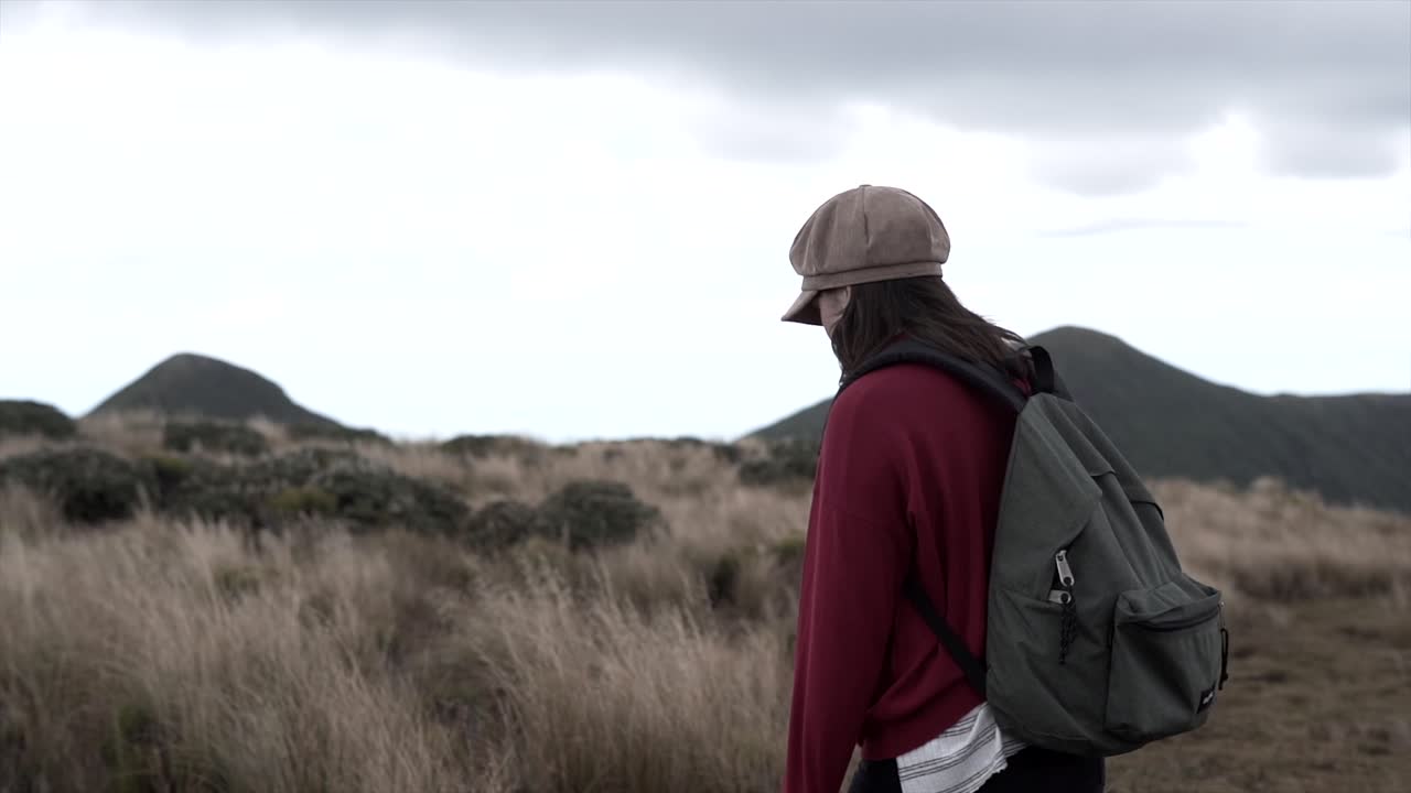 Woman with a backpack in a mountain landscape