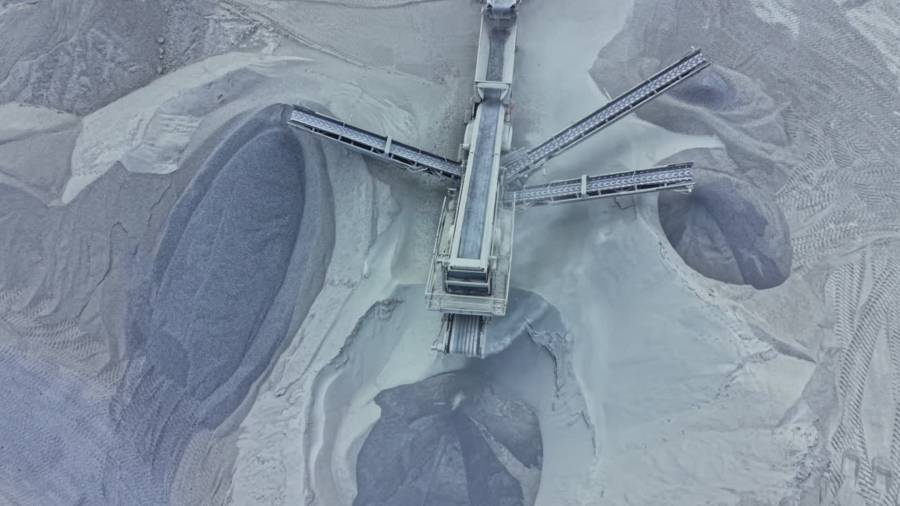 Granite quarry with machinery and storage areas showing the process of extracting and processing stone materials in an industrial setting