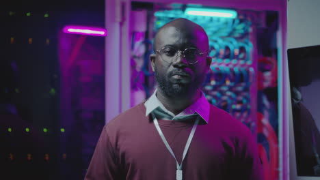 portrait of a male it engineer in a server room