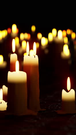 close-up of candles burning in the dark