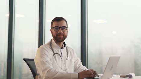 Close-up-portrait-of-a-male-doctor-looking-at-the-camera-and-smiling