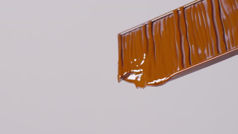 close up of melting chocolate bar against white background with copy space 3