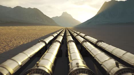 Five-streams-of-a-pipeline-with-heat-pipes-running-through-a-beautiful,-scenic,-foggy-desert-with-vast-mountains-in-the-background.-Fuel-travelling-through-a-pipe-system-supplying-petroleum.