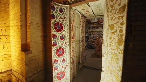 khiva merchant shop entrance, embroidered fabric, old city. uzbekistan silk road at night 2