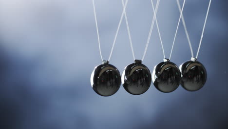 newton's cradle - demonstrates the law of energy conservation momentum is transmitted from one ball to another