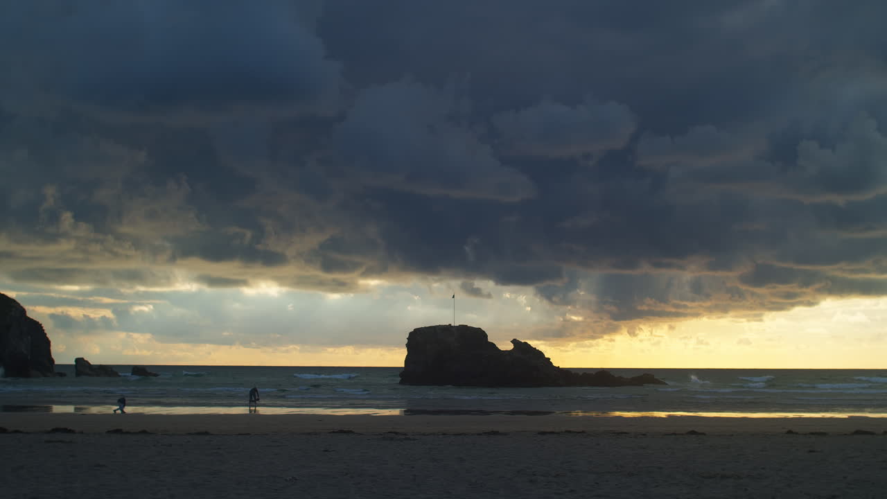 Dusky Clouded Sky Over Perranporth Beach During Sunset In Cornwall, England. Wide Shot