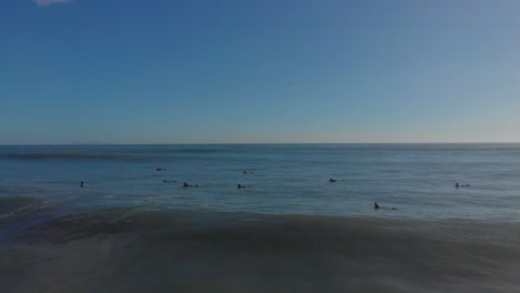 AERIAL:-Surfers-at-Mount-Maunganui-Beach,-New-Zealand