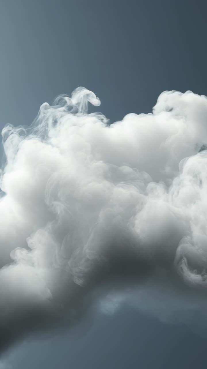 Dramatic clouds floating in a clear sky. Thick, fluffy clouds drift across a bright sky, casting shadows as the sun shines brightly above.