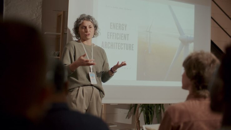Female Speaker Presenting Energy Efficient Architecture at Conference